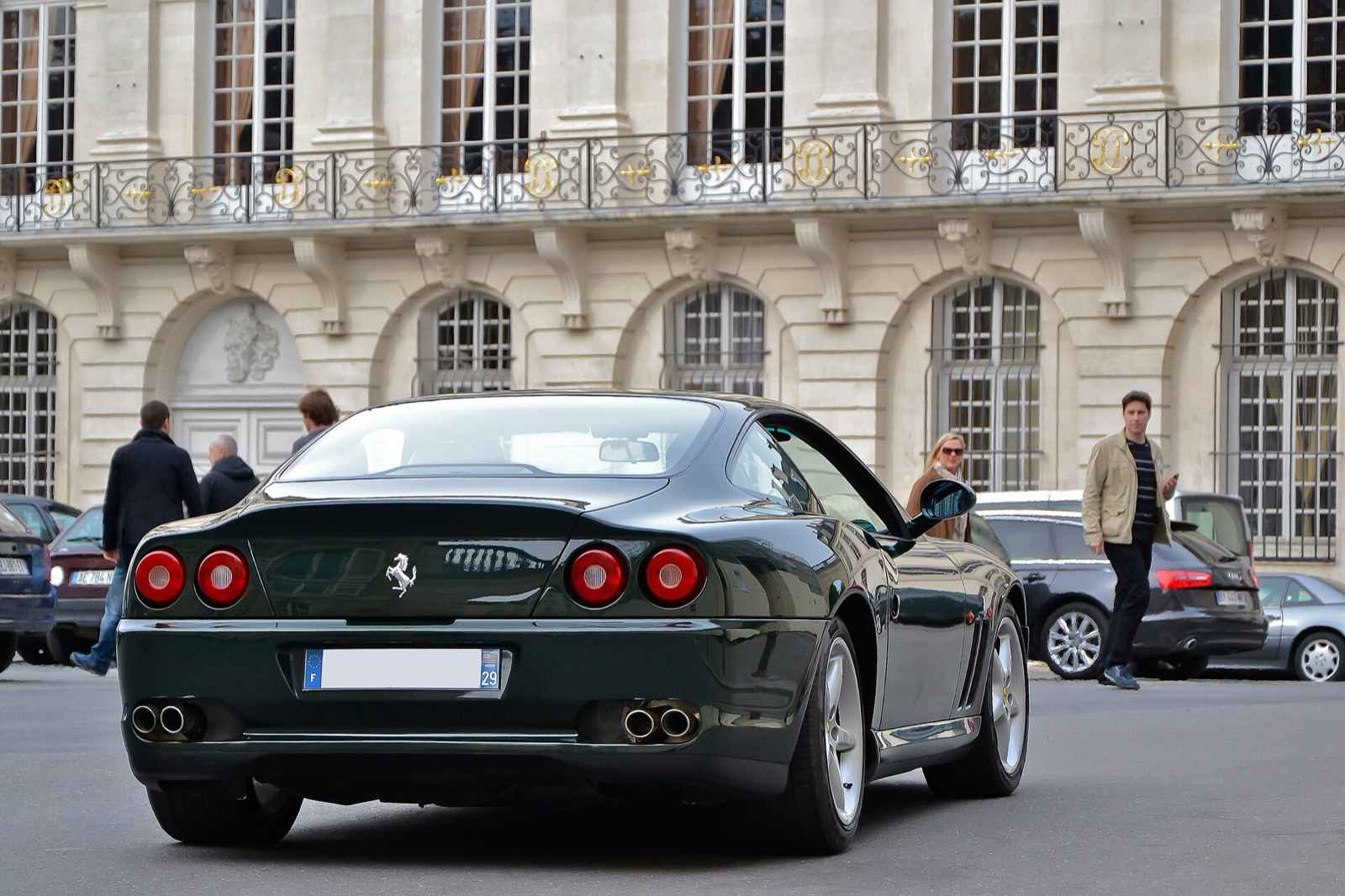 Dark green Ferrari 550 Maranello from behind, parked in front of a classical facade in Paris