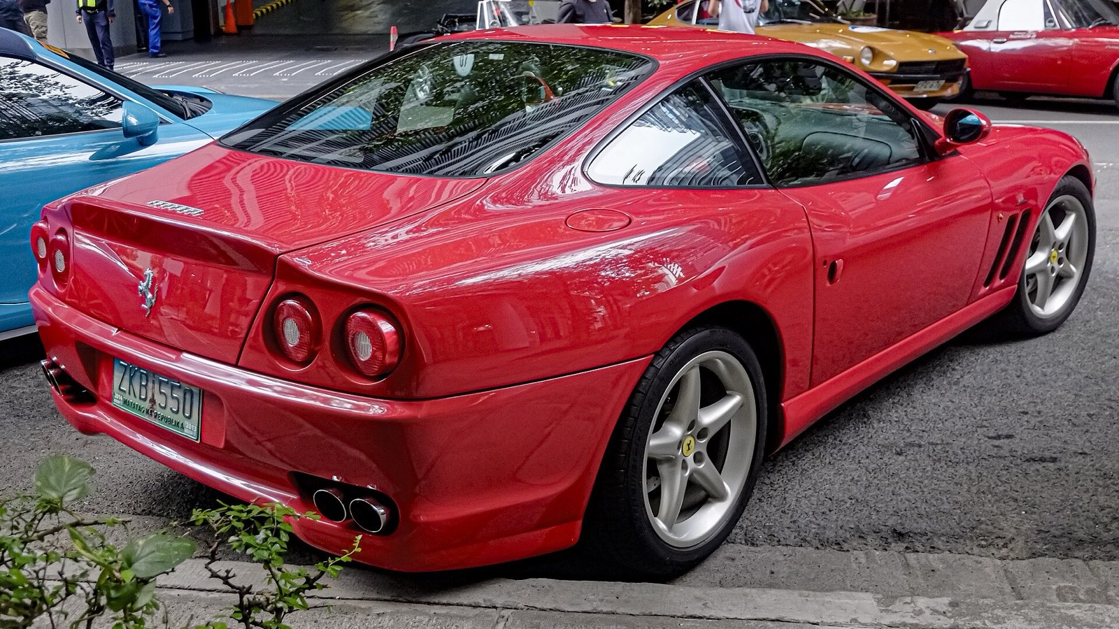 Red Ferrari 550 Maranello rear three-quarter view showing the quad round tail lights