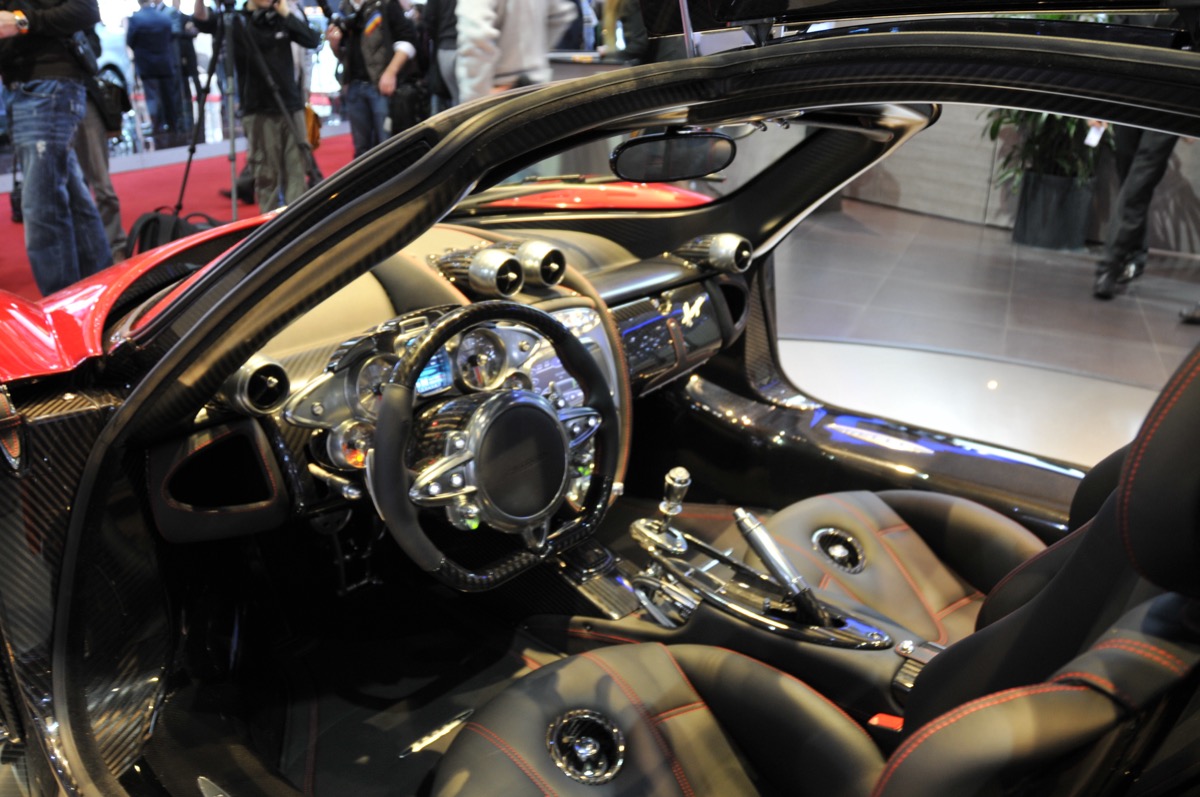 Pagani Huayra with gull-wing doors open — carbo-titanium bodywork, every surface describing a curve
