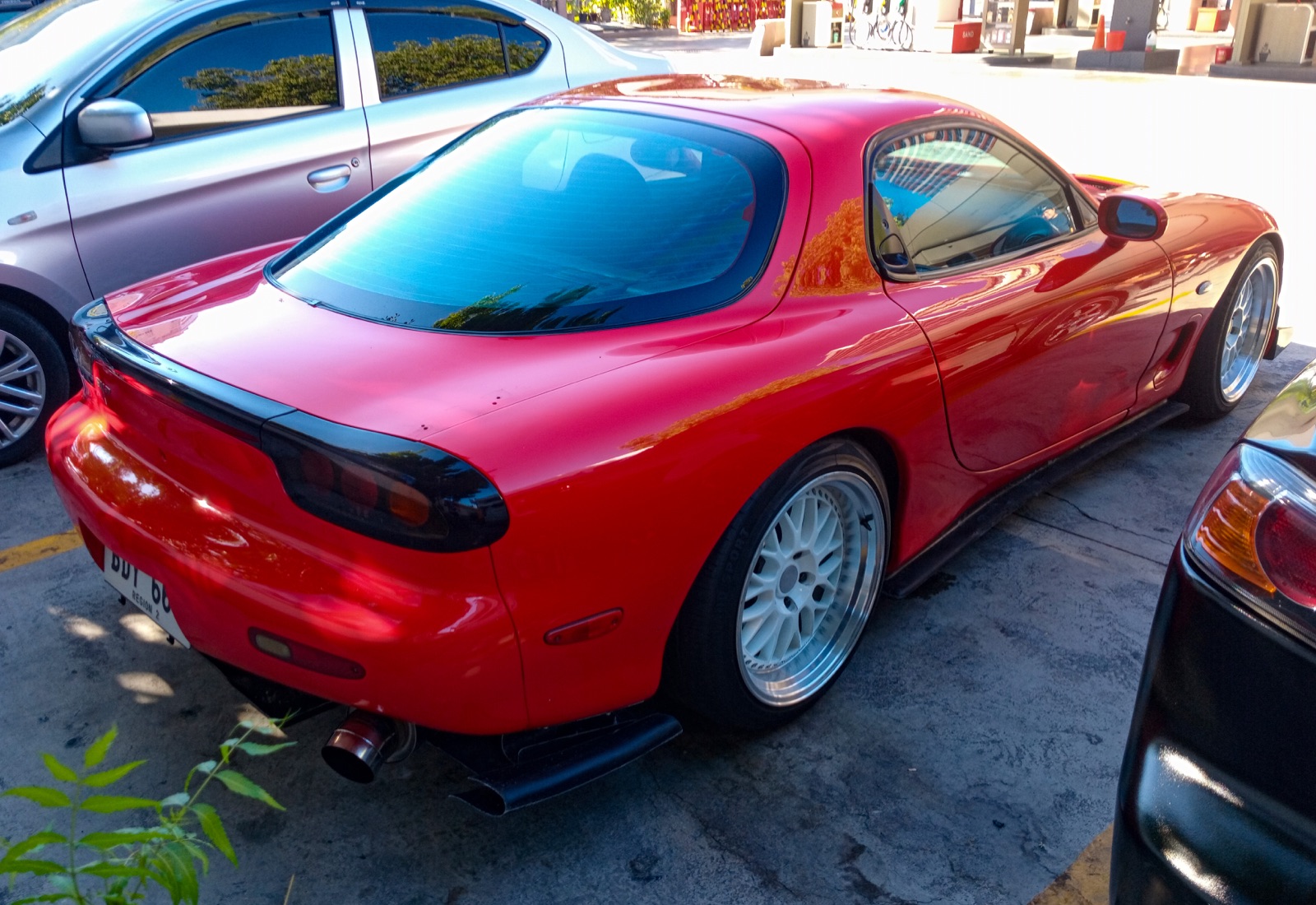 Mazda RX-7 FD3S rear three-quarter showing the wide rear haunches and quad tail lights