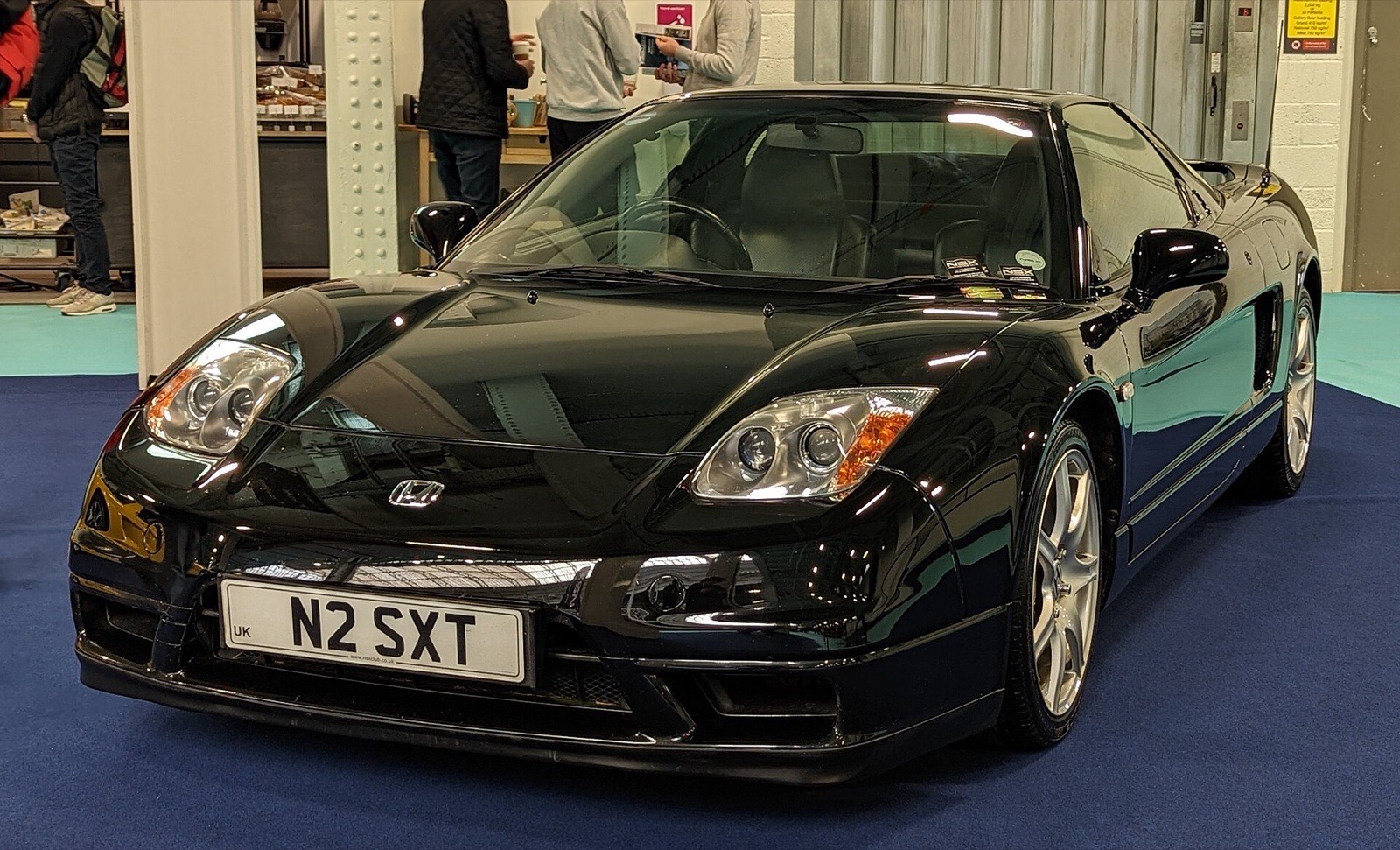 Black 2003 Honda NSX showing the fixed xenon headlights introduced with the 2002 facelift