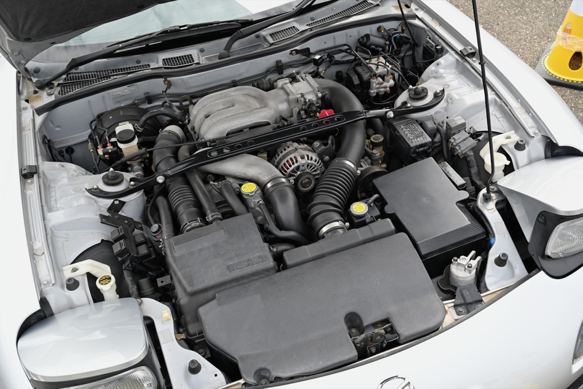 The 13B-REW sequential twin-turbo setup in the FD RX-7 engine bay — two rotors, two turbos, no reciprocating pistons
